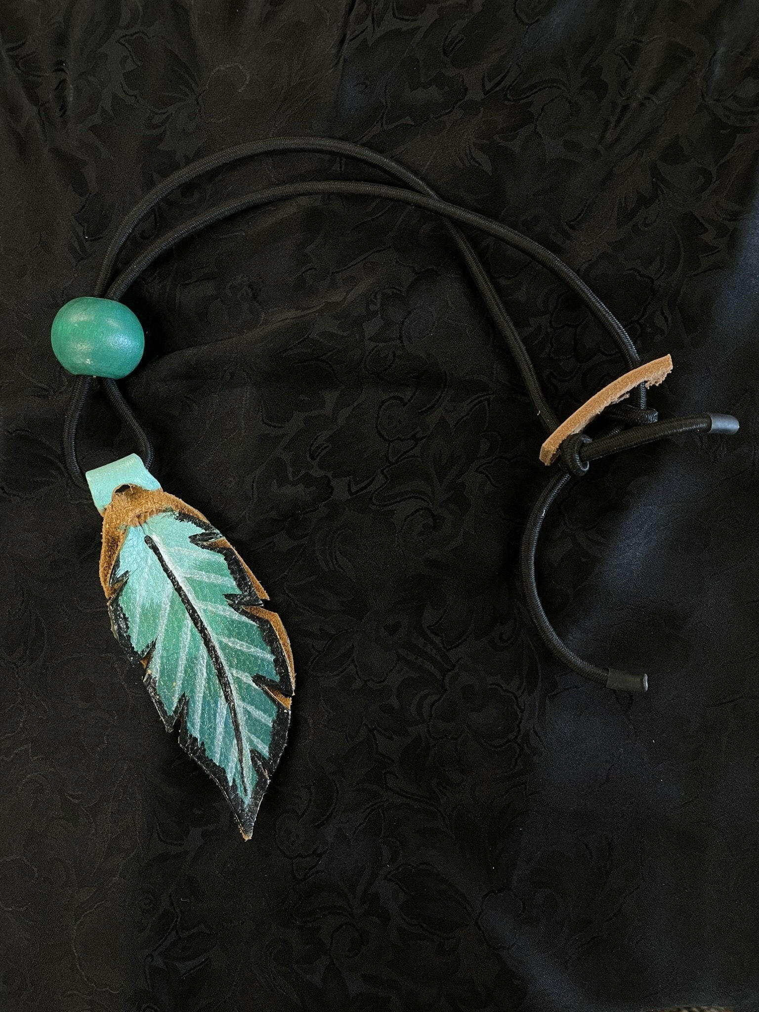Confused Compass Feather Rope Holder.